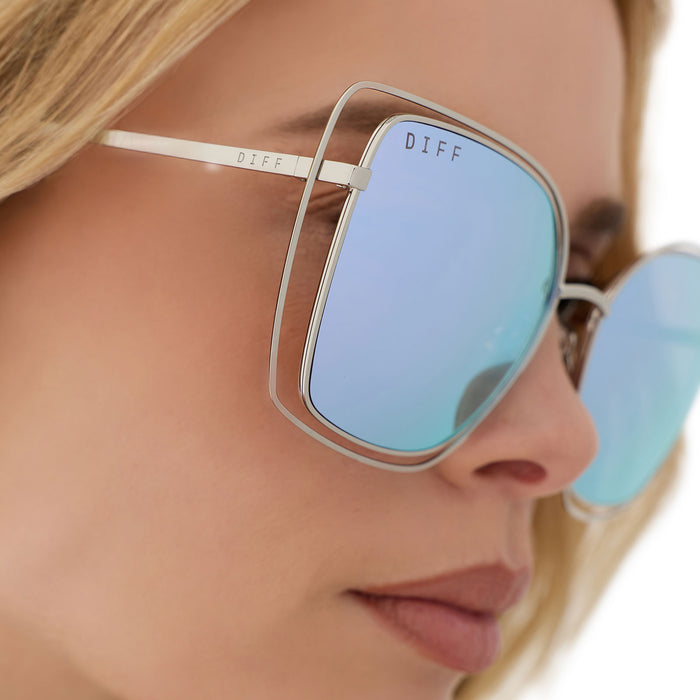on model - female wearing diff eyewear featuring the jacqueline square sunglasses with a silver thistle temple tips frame and lavender mirror lenses detailed view