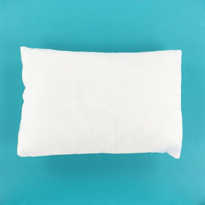 A plain white rectangular pillow or cushion shown from above on a bright turquoise-blue background.