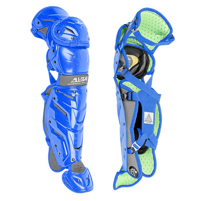 The All Star System7 Axis Catcher's Leg Guards are shown in blue, displaying protective padding, knee caps, adjustable straps, and green/black interior cushioning with a LINQ hinge system for enhanced mobility.