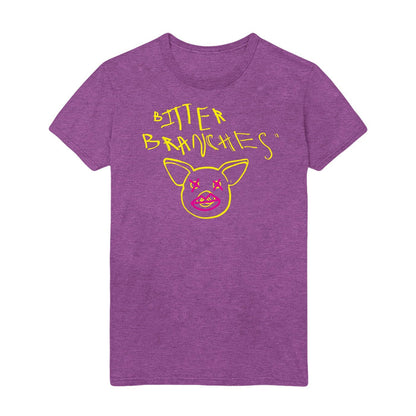 Purple tshirt with scratchy style yellow text reading Bitter Branches on the top part of the shirt with a yellow outline of a pig face below. Pink Xs are drawn over the pig's eyes and pink lips are drawn over the pig's snout.