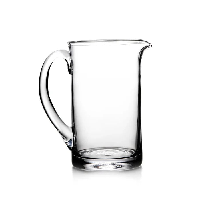 Medium Ascutney pitcher by Simon Pearce, made of clear glass with a sleek, elegant design for serving beverages.