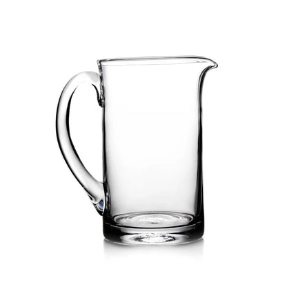 Medium Ascutney pitcher by Simon Pearce, made of clear glass with a sleek, elegant design for serving beverages.