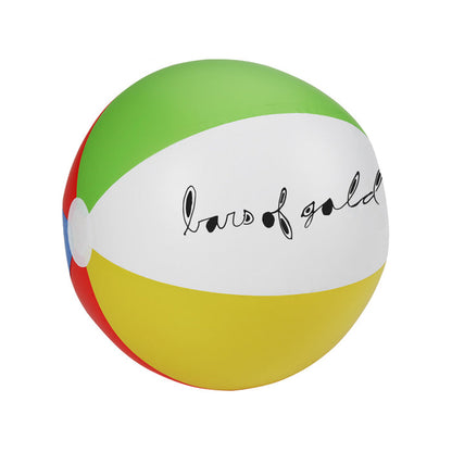 Red, blue, yellow, green, and white beach ball with "bars of gold" written in lowercase black cursive on the white side.