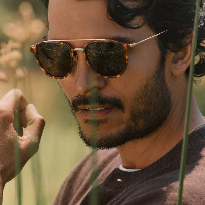 lifestyle - male outdoors wearing diff eyewear camden aviator sunglasses with a rich tortoise frame and brown polarized lenses front view