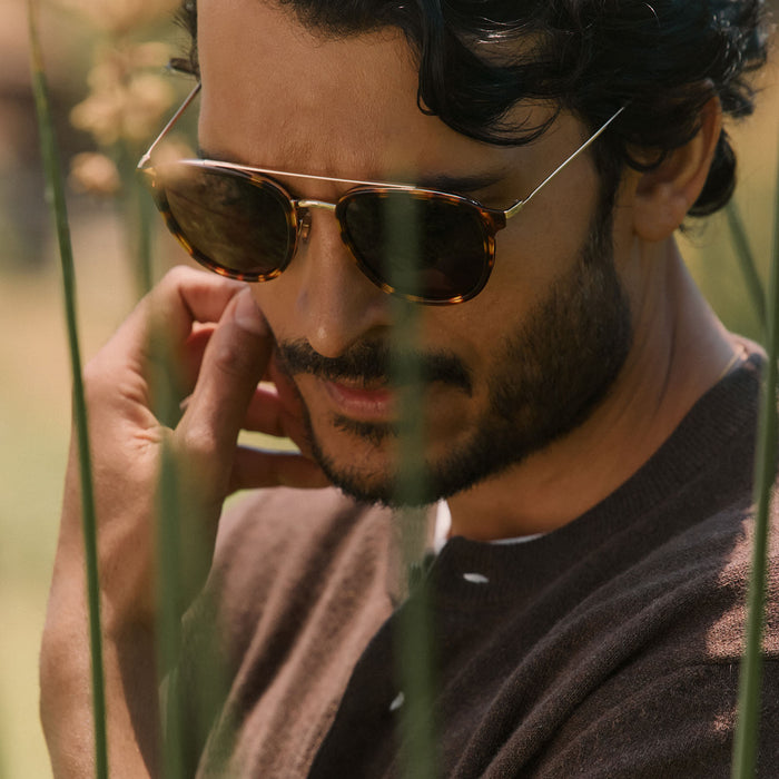 lifestyle - male outdoors wearing diff eyewear camden aviator sunglasses with a rich tortoise frame and brown polarized lenses angled view
