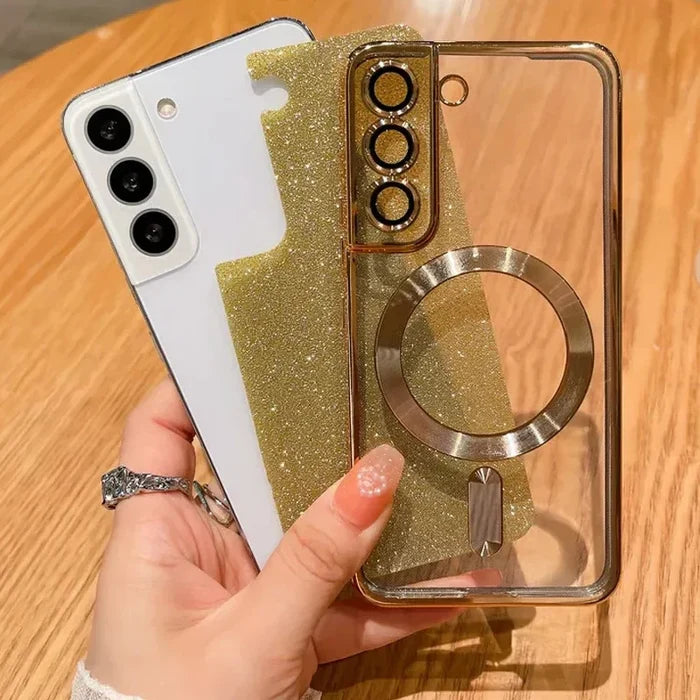Smartphone with a glittery gold and clear protective case featuring a ring holder.