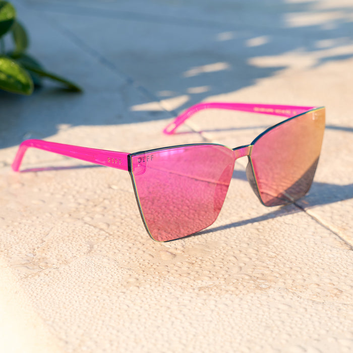 still life - diff eyewear featuring the goldie cat eye sunglasses with a bright tulip frame and pink rush mirror lenses