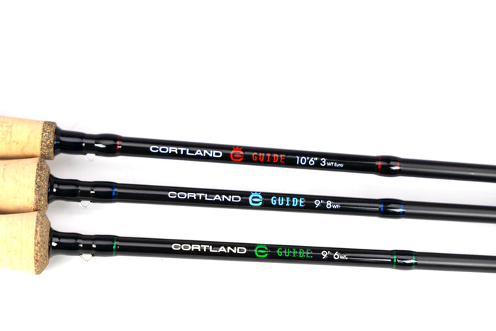 Three Cortland fishing rods with cork handles on a white background