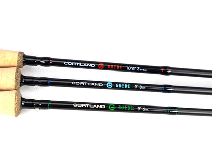 Three Cortland fishing rods with cork handles on a white background