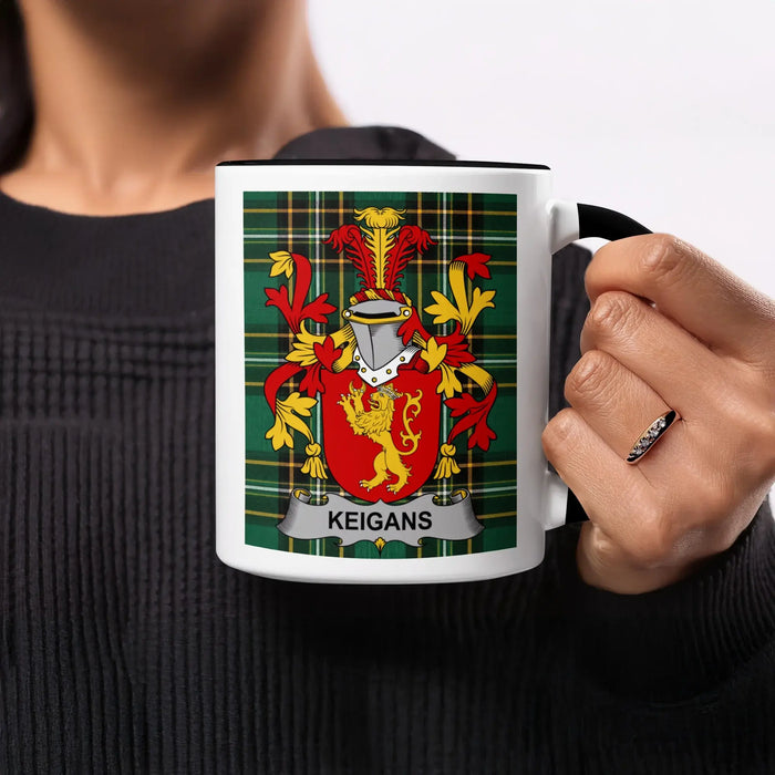 Black and white mug with Keigans family crest on plaid background.