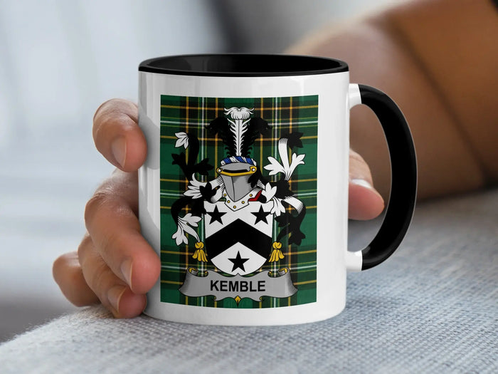White mug with black trim featuring a Kemble family crest on green plaid.