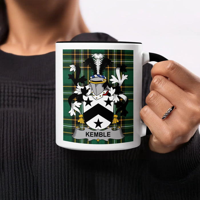 Black mug with Kemble family crest on tartan background.