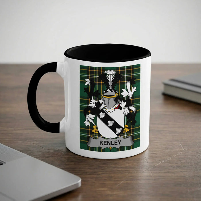 White mug with black rim and handle, featuring a green plaid coat of arms with the name "KENLEY".