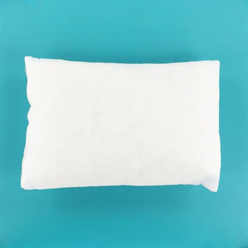 A plain white rectangular pillow or cushion shown from above on a bright turquoise-blue background.