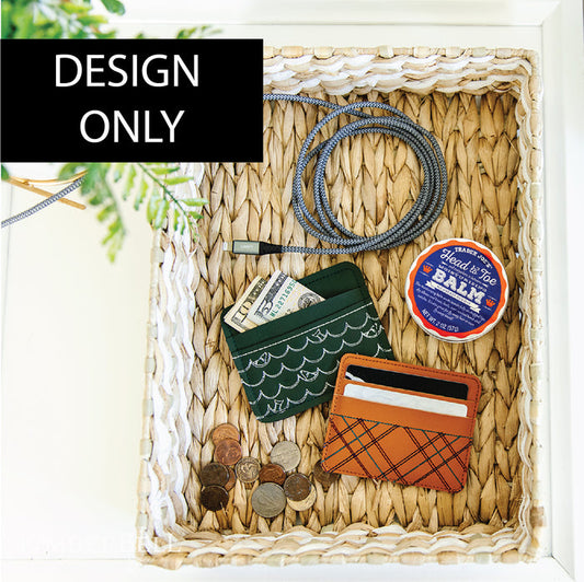 Two embroidered leather card wallets in a woven basket.