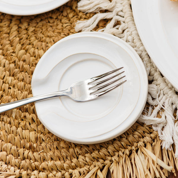 Vietri Luna Spoon Rest in white ceramic with moon and star design, perfect for holding utensils on a countertop.