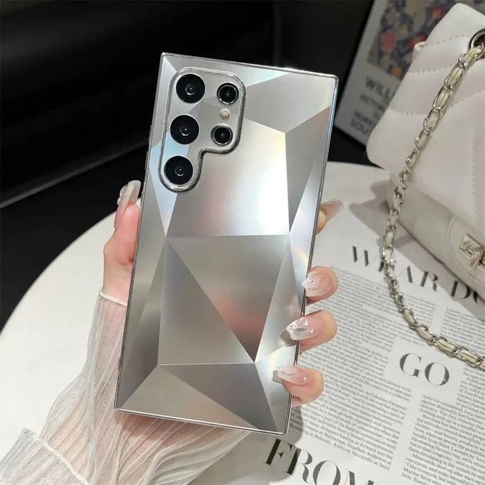 A woman holding a phone case with a diamond design