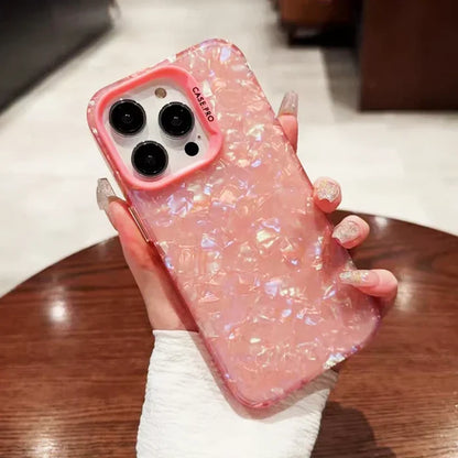 a person holding a pink phone case