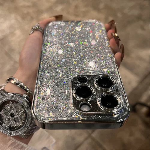 A woman holding a silver glitter phone case