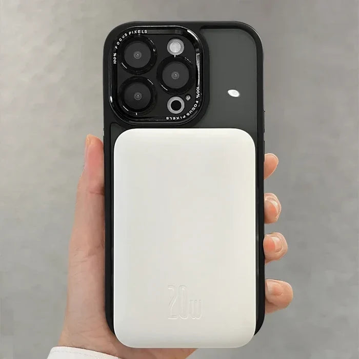 Black-cased smartphone with white MagSafe battery pack.
