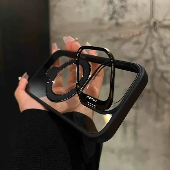 Clear phone case with black trim and ring stand.