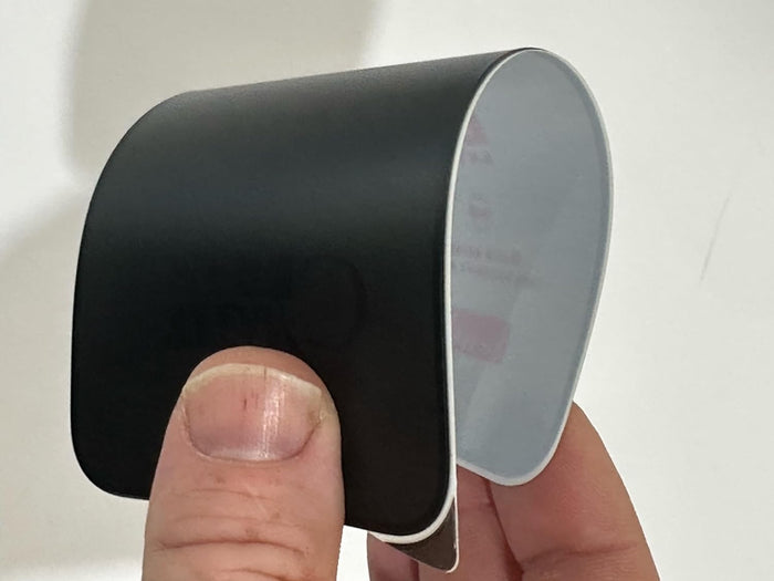 Curved black and white object.