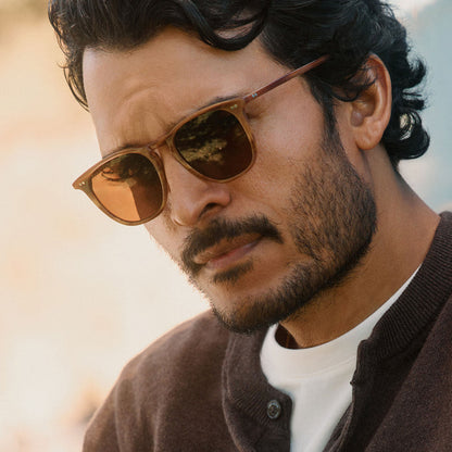 lifestyle - male wearing diff eyewear maxwell xl square sunglasses with a longhorn brown frame and brown polarized lenses angled view