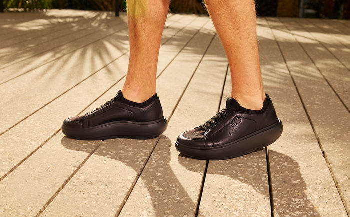 Black sneakers on a wooden floor | lifestyle