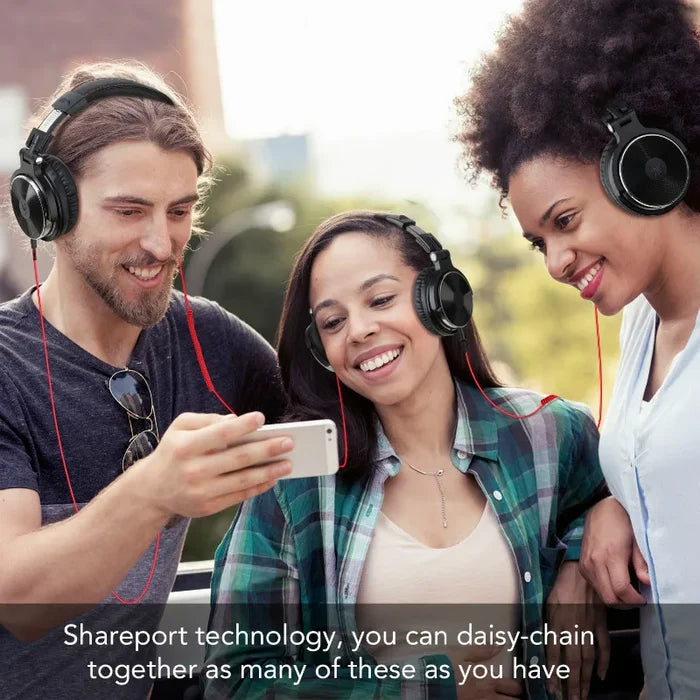 Three friends wearing headphones and looking at a smartphone together.