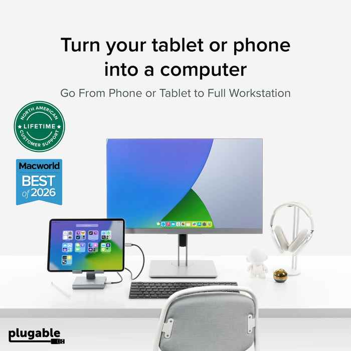 Plugable UDS-7IN1 hub connecting a tablet to a desktop monitor, keyboard, and headphones for a workstation setup.