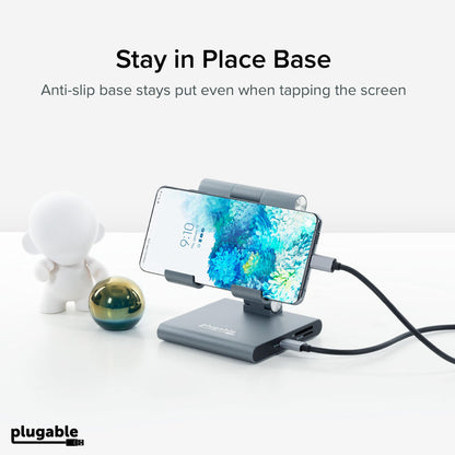 Plugable UDS-7IN1 hub with anti-slip base holding a smartphone, featuring SD and Micro SD card slots.