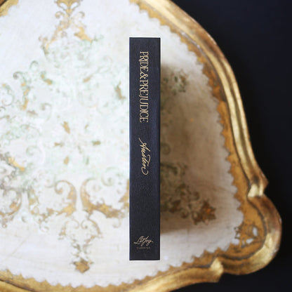 Special Edition of Pride and Prejudice by Jane Austen with gold and white illustration of Elizabeth and Mr. Darcy on a black hardcover book and a slip case