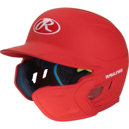 A vibrant red Rawlings Mach Matte Batting Helmet with EXT Flap (MACHEXT), showcasing the white Rawlings logo on the front and side, plus black padded interior lining for comfort.