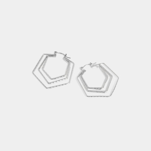 Pair of silver hoop earrings on a light gray background