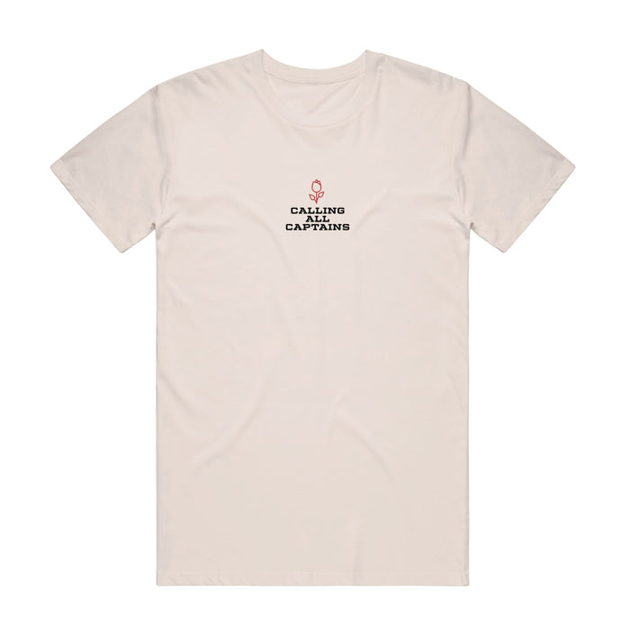 Cream colored short sleeve shirt with CALLING ALL CAPTAINS written across the chest in black font. Above the text there is a small red rose.
