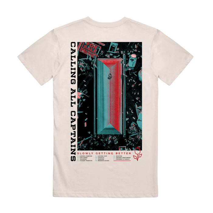 Back of cream colored short sleeve shirt with text along the side that says CALLING ALL CAPTAINS. In the center there is artwork of a coffin laying in grass surrounded by trash. Below that there is text that says SLOWLY GETTING BETTER.