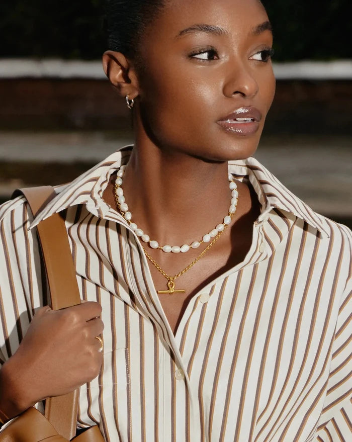pearl necklace with a chunky gold t-bar necklace