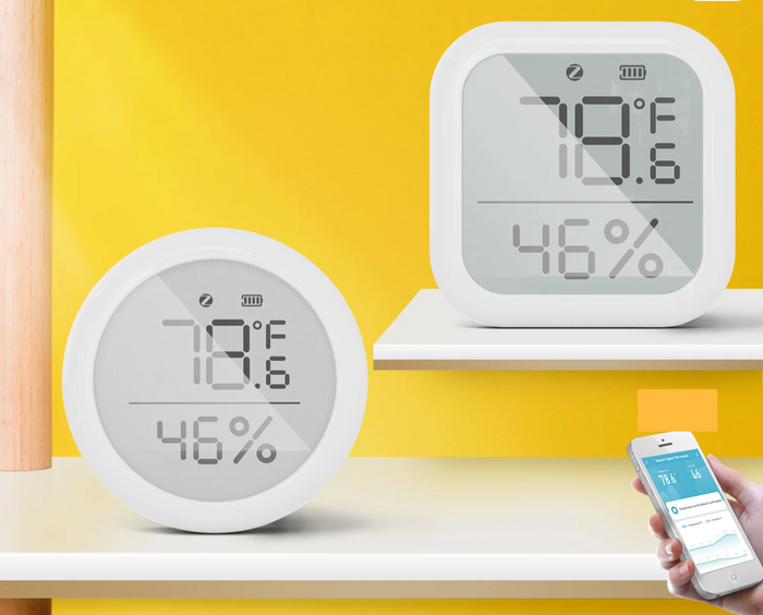 Two white digital temperature and humidity monitors.
