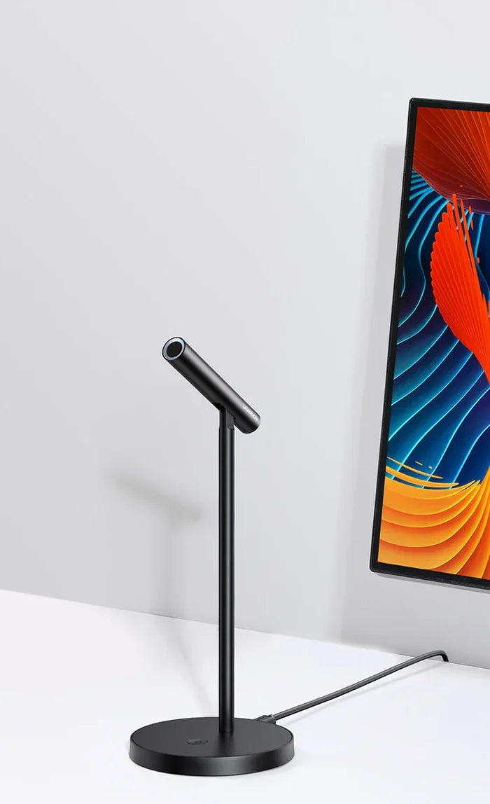 Black desk lamp with a slender adjustable arm and circular base.