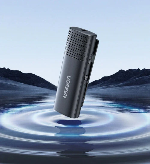 Sleek black microphone or audio recording device with a perforated top half.