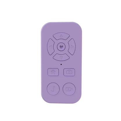 Lavender-colored remote control with circular and rectangular buttons.