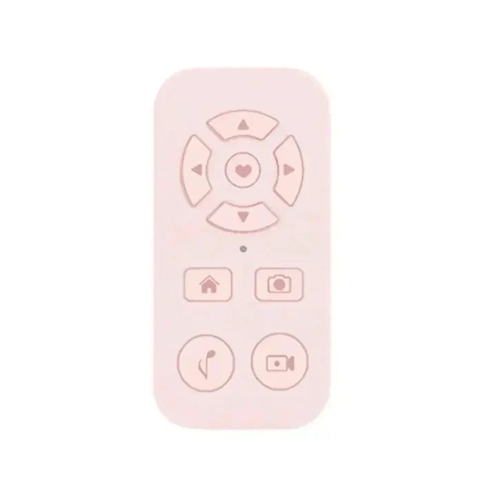 Pale pink remote control with heart-centered directional pad and function buttons.