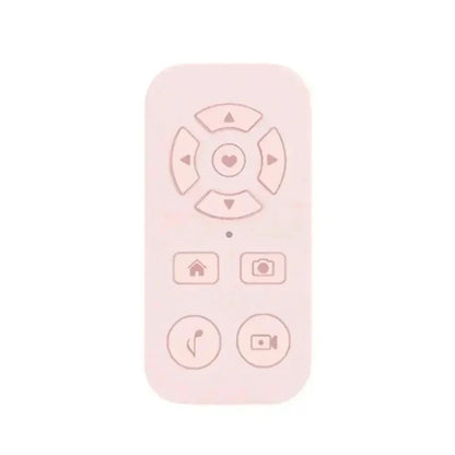 Pale pink remote control with heart-centered directional pad and function buttons.