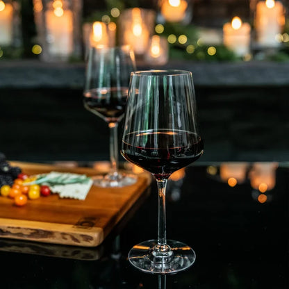 Set of two Simon Pearce Vintner Red Wine glasses with clear glass and elegant design.