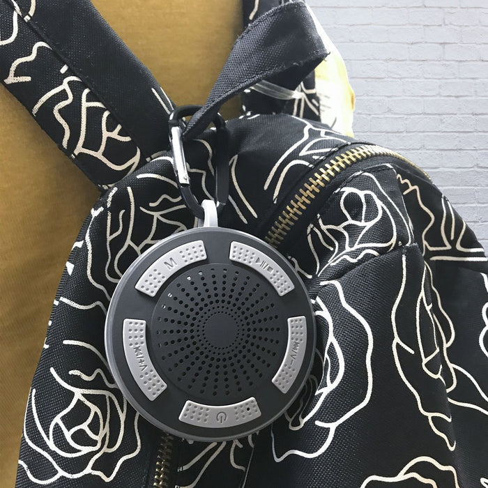 i simple bluetooth speaker attached on backpack with carabiner