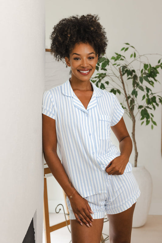 Female model leaning against a wall wearing the Women's Short Sleeve Pajama Set in Small Mist Stripe