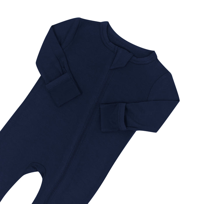 Close up of zipper garage and fold over cuffs on Kyte Baby Zippered Romper in Navy